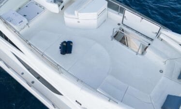 Flybridge helm and lounge area on a Ferretti 46 yacht, private yacht cruise in Paros.