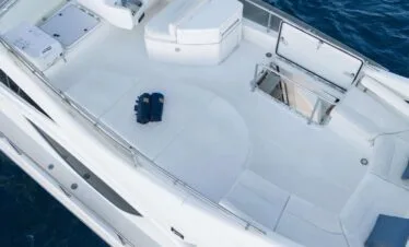 Flybridge helm and lounge area on a Ferretti 46 yacht, private yacht cruise in Paros.