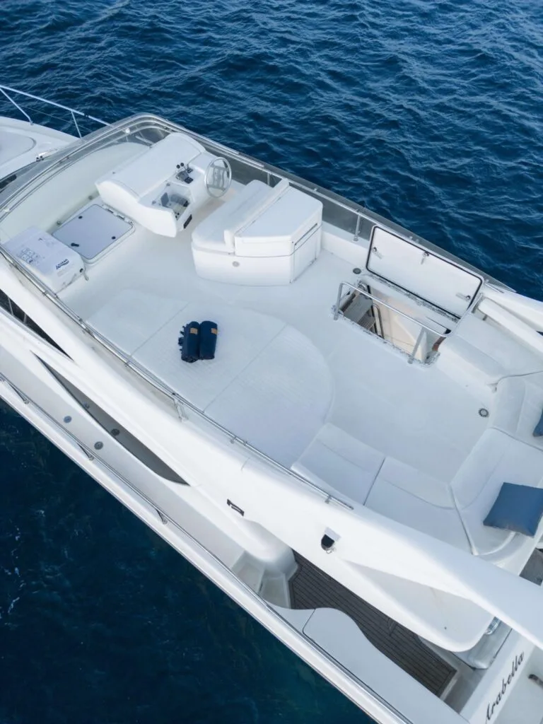 Flybridge helm and lounge area on a Ferretti 46 yacht, private yacht cruise in Paros.