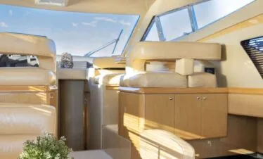 Indoor seating and dining area on a Ferretti 46 yacht, private yacht cruise in Paros.