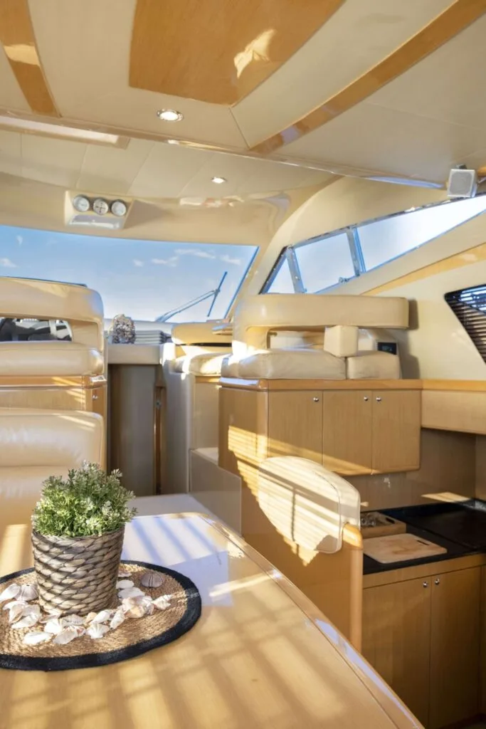 Indoor seating and dining area on a Ferretti 46 yacht, private yacht cruise in Paros.